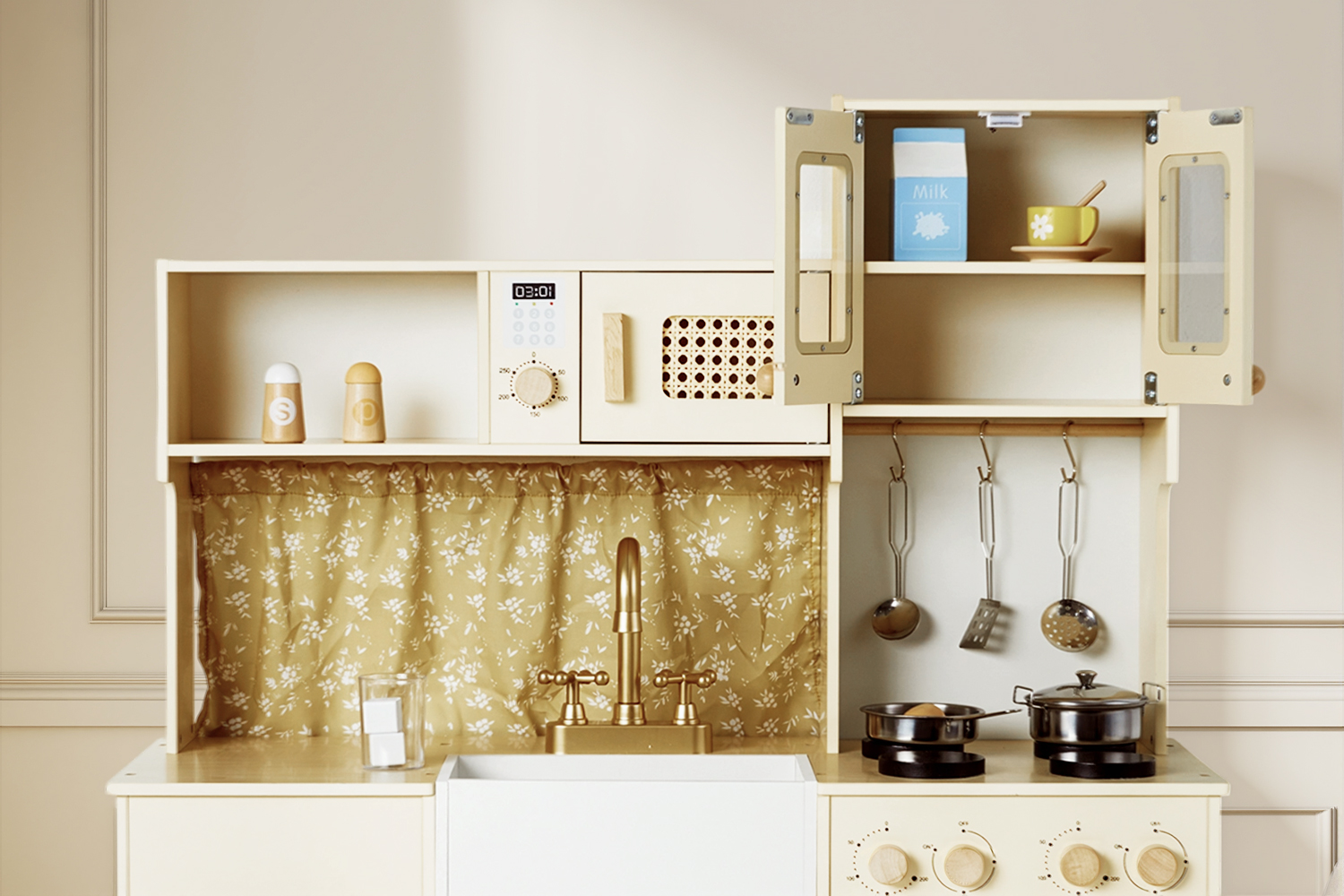 Close-up of cream wooden play kitchen with open cabinets, hooks, sink and toy cookware